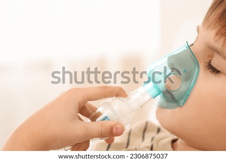 Similar – Image, Stock Photo Cute preteen boy inhales the air of freedom from car window during family road trip and enjoy of pleasant expectation of happy vacation. Joyful child travel with parents