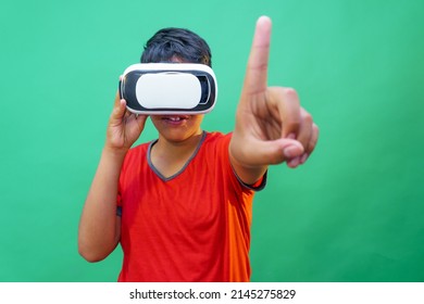 boy using virtual reality simulator headset on green background
