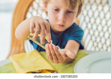 Boy Using Wash Hand Sanitizer Gel In The Cafe.