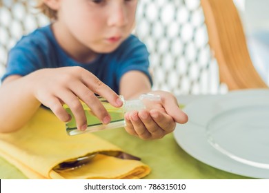 Boy Using Wash Hand Sanitizer Gel In The Cafe.