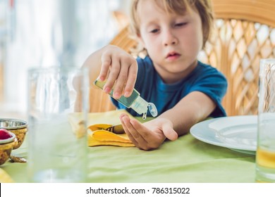 Boy Using Wash Hand Sanitizer Gel In The Cafe.