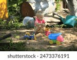 A boy is walking in the yard.