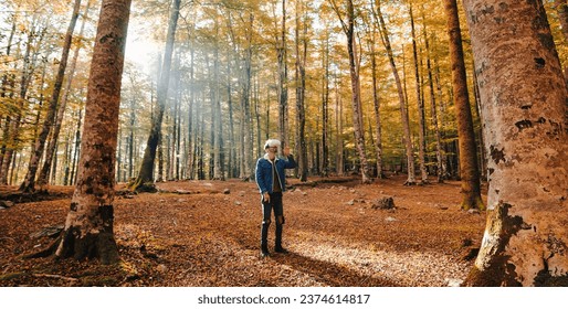 Boy walks with vr viewer in the mountains in Autumn