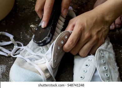  Boy Washes A Pair Of  Dirty White Shoes , Sneakers  By Hands With Brush  /cleaning Shoes At Home