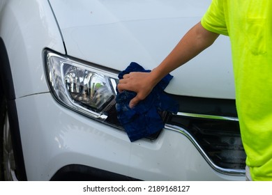 A Boy Washes A White Car With A Rag In The Summer At The Dacha Himself.