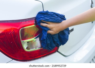 A Boy Washes A White Car With A Rag In The Summer At The Dacha Himself.