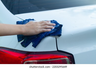 A Boy Washes A White Car With A Rag In The Summer At The Dacha Himself.