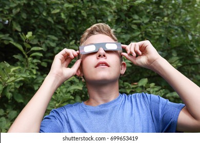 Boy Watching The Eclipse Of The Sun