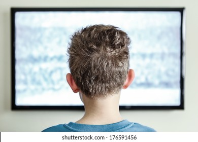 Boy watching Television with noise