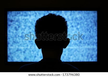 Boy watching television with noise