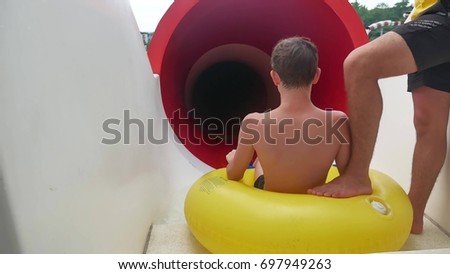 The boy in the water park. Boy rolls downhill in the water park amusement park