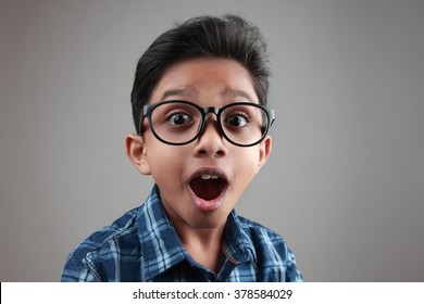 Boy wearing a big spectacle with a shocked expression