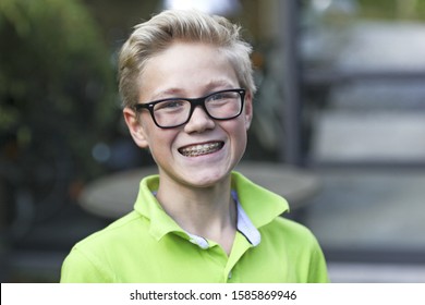 Boy Wearing Braces Smiling At Camera