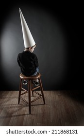 Boy Wearing A Dunce Cap