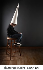 Boy Wearing A Dunce Cap