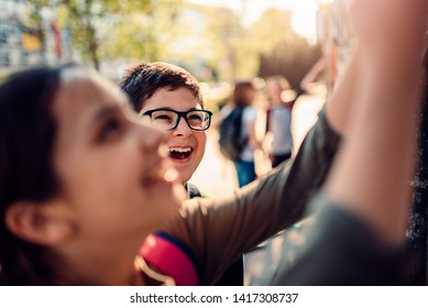 Boy Wearing Eyeglasses Hang Out With His Friends And Laughing