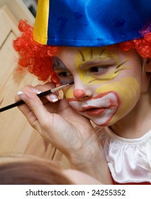 The boy wearing funny clown