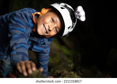 Boy Wearing Helmet For Caving Inside Caves