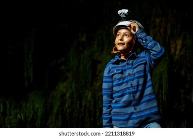 Boy Wearing Helmet For Caving Inside Caves