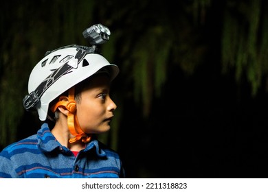 Boy Wearing Helmet For Caving Inside Caves