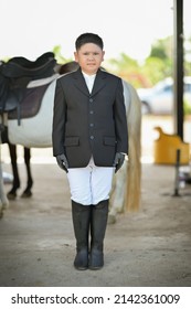 Boy Wearing A Horse Riding Suit Wearing White Pants Black Boots