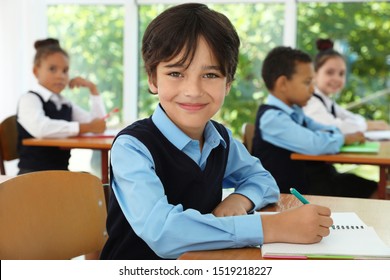 Boy Wearing New School Uniform In Classroom