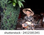 boy wearing Okinawan folk costume and drawing a sanshin line
