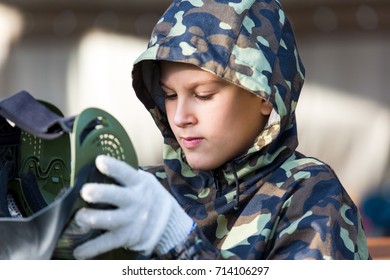 A Boy Is Wearing Paintball Helmet.