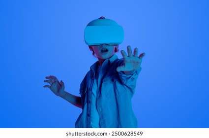 Boy wearing VR headset, interacting with virtual environment. Blue background highlights the immersive experience of virtual reality. - Powered by Shutterstock