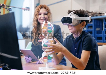 Boy wearing vr headset interacting with dna model in classroom, AI intelligence technology for child in school.
