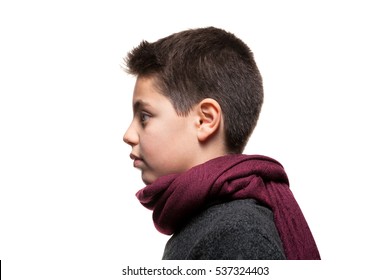 Boy Wearing Woolen Sweater And Red Scarf, Portrait In Studio, Profile View