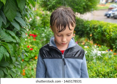 The Boy Is Wet In The Rain And Ashamed. The Mother Scolding The Boy.