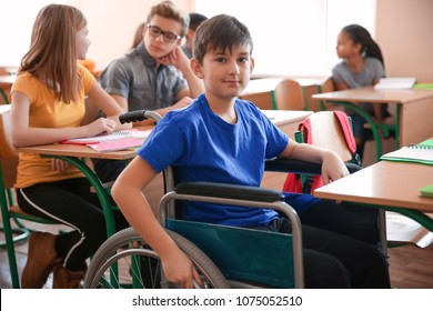 Boy In Wheelchair In Classroom At School