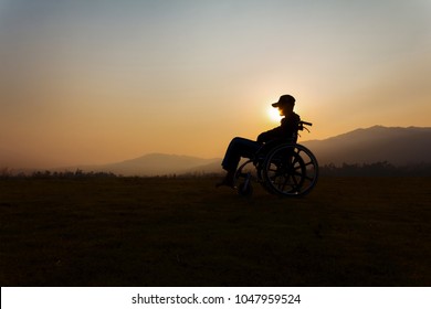 Boy whit wheelchair at sunset time, disabled human concept - Powered by Shutterstock