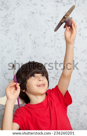 boy with a wooden plane and brush