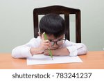Boy writing a book in the house.