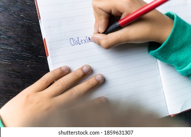 Boy Writing Dyslexia In His Notebook, Wrong Spelling. Learning Disorder