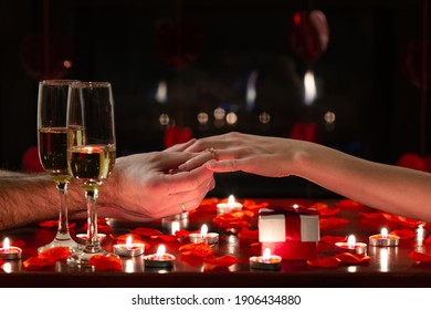 Boyfriend asking her girlfriend to marry him with a shiny ring on her finger. Engagement scene for Valentine’s Day celebration during romantic dinner. Concept about lifestyle, proposal and love.  - Powered by Shutterstock
