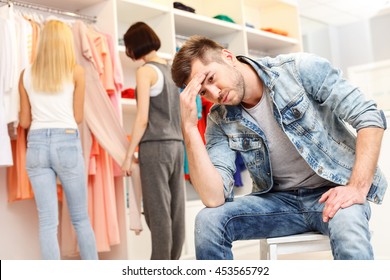 Boyfriend is bored in shop - Powered by Shutterstock