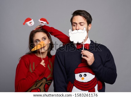Boyfriend and girlfriend with Christmas masks