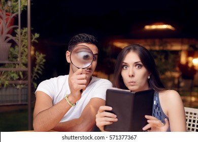 Boyfriend And Girlfriend Surprised By The Expensive Restaurant Bill - Funny Couple Inspecting The Check After Dinner Date
