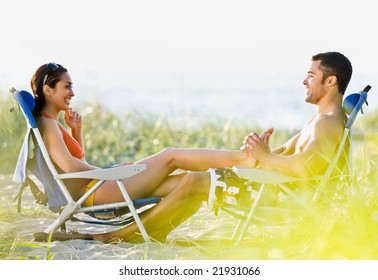 Boyfriend Giving Girlfriend Foot Massage At Beach