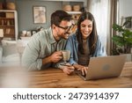 Boyfriend husband and girlfriend wife buy online on laptop with credit card at home