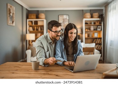 Boyfriend husband and girlfriend wife buy online on laptop with credit card at home - Powered by Shutterstock