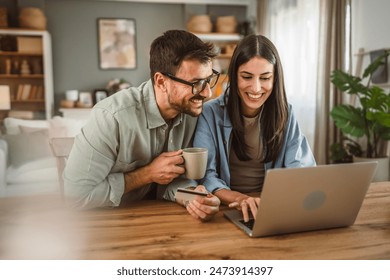 Boyfriend husband and girlfriend wife buy online on laptop with credit card at home - Powered by Shutterstock