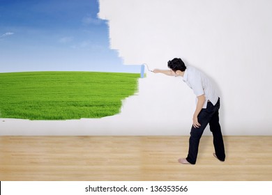 Boyfriend painting green field on wall
