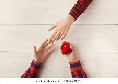 Boyfriend Putting Ring On Girlfriend Finger. Man Propose To Marry Him. Happiness, Relationships, Love, Engagement Concept, Copy Space, Top View