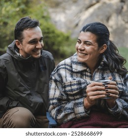 boyfriend take care of his girlfriend and share tea with her on camping trip - Powered by Shutterstock