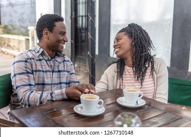 Boyfriends talking in front of a cup of coffee. - Shutterstock ID 1267710148