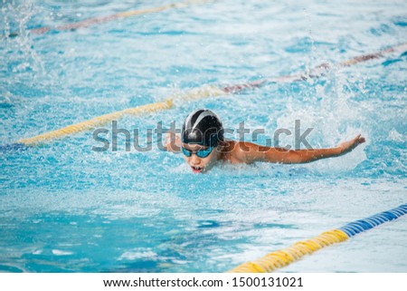 The boys compete in swimming butterfly